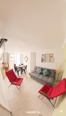 a living room with red chairs and a couch at Apartamento, Arena Dorada, Coveñas in Coveñas