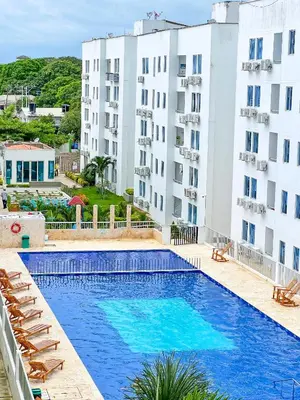 a pool in front of two tall buildings at Teca, Apto , Caribe in Coveñas