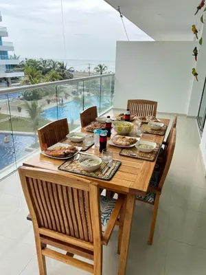 a wooden table with plates of food on it at NOK Oceanside getaway in Cartagena in Cartagena de Indias