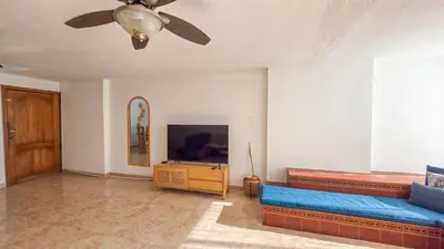 a living room with a blue couch and a flat screen tv at Apt 3 rooms Laguito Cartagena 1 block from the beach in Cartagena de Indias