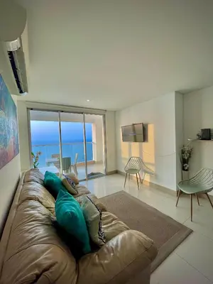 a couch in a living room with a view of the ocean at Apartamento de 2 Habitaciones Vista al Mar in Cartagena de Indias