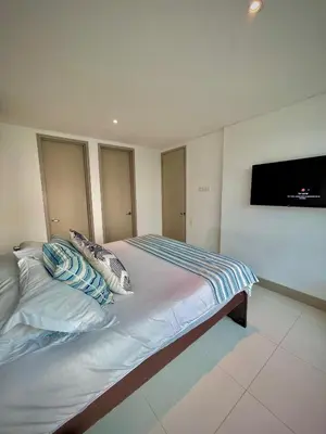 a bedroom with a bed and a flat screen tv at Apartamento de 2 Habitaciones Vista al Mar in Cartagena de Indias