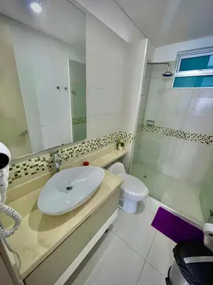 a bathroom with a sink and a toilet and a mirror at Apartamento de 2 Habitaciones Vista al Mar in Cartagena de Indias