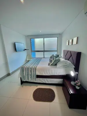 a bedroom with a large bed and a window at Apartamento de 2 Habitaciones Vista al Mar in Cartagena de Indias