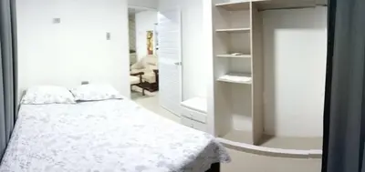 a white bedroom with a bed and a mirror at Posada mary in Cartagena de Indias