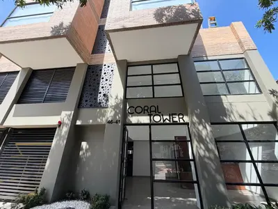 a building with a sign that reads coral order at Suite Coral Tower in Barranquilla