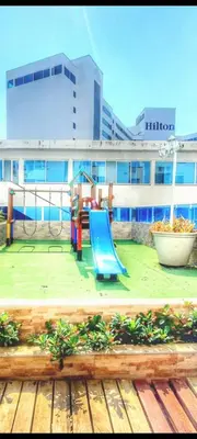 a playground with a blue slide in front of a building at Azul Caribe Home in Cartagena de Indias