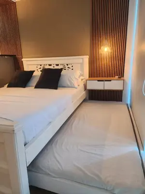 a bedroom with a white bed with a night stand at Lagoon & see view studio Cartagena in Cartagena de Indias