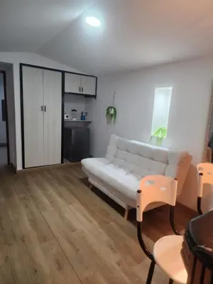 a living room with a white couch and a kitchen at Lagoon & see view studio Cartagena in Cartagena de Indias