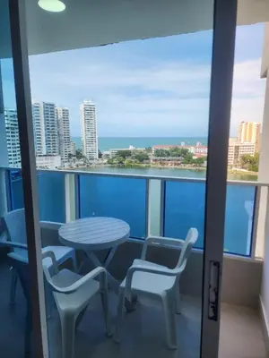 a table and chairs on a balcony with a view of the ocean at Lagoon & see view studio Cartagena in Cartagena de Indias