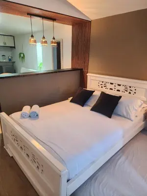 a bedroom with a large bed with two towels on it at Lagoon & see view studio Cartagena in Cartagena de Indias