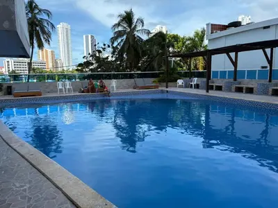 a large swimming pool with blue water in a city at Lagoon & see view studio Cartagena in Cartagena de Indias