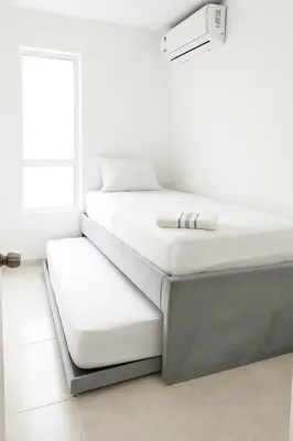 a stack of white beds in a room at Cartagena Apartamento completo vista al mar in Cartagena de Indias