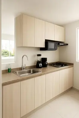 a kitchen with wooden cabinets and a sink at Cartagena Apartamento completo vista al mar in Cartagena de Indias