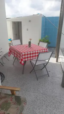 a red and white table and chairs on a balcony at Hostal Casa Adela