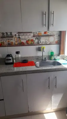a kitchen with a sink and a counter top at Hostal Casa Adela