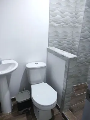 a white bathroom with a toilet and a shower at Hotel La Dorada Sincelejo in Sincelejo