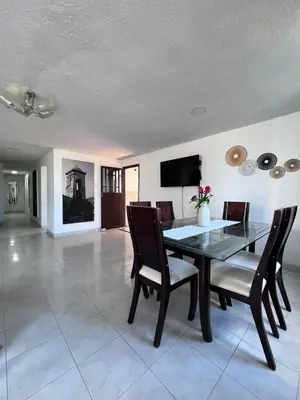 a dining room with a glass table and chairs at White House in Cartagena de Indias