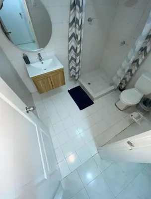 a bathroom with a sink and a toilet and a mirror at White House in Cartagena de Indias