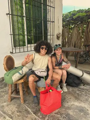 a couple of people sitting on a bench at Casa Grulla in Santa Marta