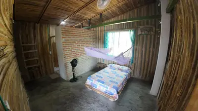 an overhead view of a bedroom with a bed and a hammock at Casa Grulla in Santa Marta