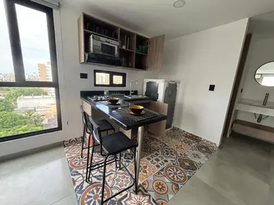 a kitchen with a island in the middle of a room at Delux Suite Coral Tower in Barranquilla