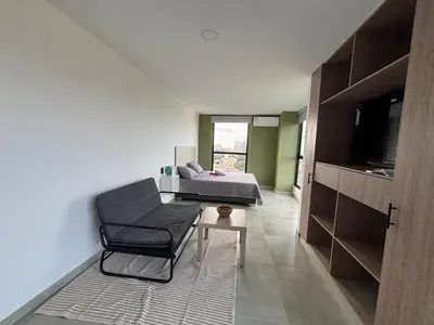 a living room with a couch and a table at Delux Suite Coral Tower in Barranquilla