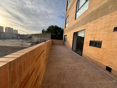 a walkway in front of a brick building at Deluxe Suite with Terrace in Barranquilla