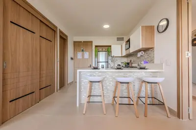 a kitchen with a counter and stools in a room at Cartagena getaway - Laguna Cristalina - 2BR - 7 pax in Cartagena de Indias