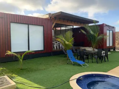 a house with a pool and a table and chairs at Habitacion doble en Villakite ,Salinas del Rey in Juan de Acosta
