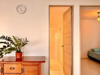 a bathroom with a shower and a clock on the wall at Modern Apartment with Ocean Views in Cartagena de Indias