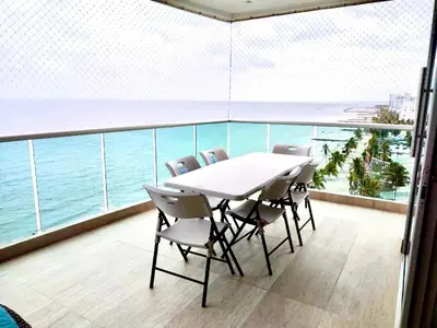 a table and chairs on a balcony with the ocean at 3BR AC Amazing View and Pool, Best sunset ever in Coveñas