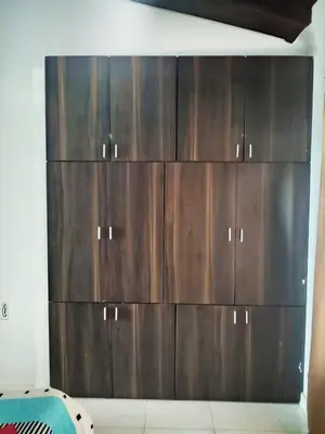 a large wooden cabinet in the corner of a room at La Cabana de Isaac Boquilla in Cartagena de Indias
