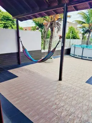 a hammock in a pavilion with a palm tree at La Cabana de Isaac Boquilla in Cartagena de Indias