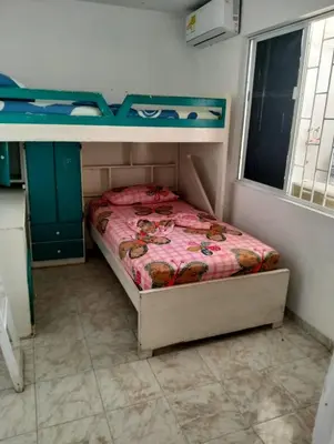 a small bedroom with a bed and a desk at La casa de la abuela cartagena in Cartagena de Indias