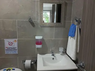 a bathroom with a sink and a mirror at Palmar in Playa Dormida