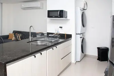 a kitchen with a sink and a refrigerator at Hermoso Apartamento con Piscina 1 Habitacion CMC66 in Cartagena de Indias