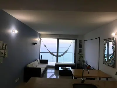 a living room with a couch and a table at Sky Ocean View in Cartagena de Indias