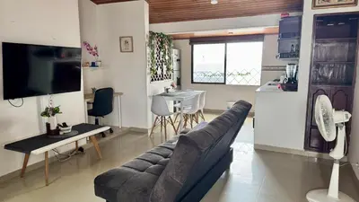 a living room with a couch and a table at Apartamento familiar, frente al mar, Bocagrande in Cartagena de Indias
