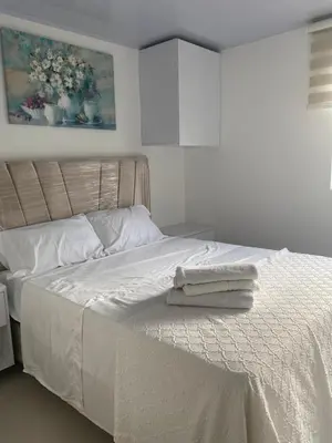 a bedroom with a white bed with towels on it at Entire apartment with amazing views Tower 811 in Cartagena de Indias
