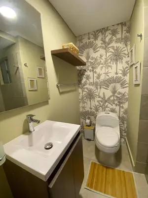 a bathroom with a white sink and a toilet at Pool , Private Beach Modern and Serene Apartment in Serena del Mar