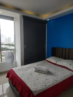a bedroom with a large bed with a blue wall at Cartagenafantastica in Cartagena de Indias