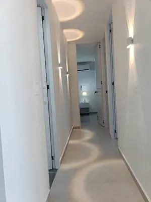 a hallway with white walls and a hallway with lights at Apartamento en Cartagena amoblado con vista al mar in Cartagena de Indias