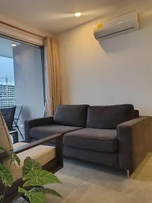 a living room with a couch and a window at Santa Marina Santa Marta - By INMOBILIARIA VS in Santa Marta