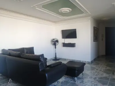a living room with a couch and a fan at Cómodo APTO En El Laguito las 3 Carabelas in Cartagena de Indias