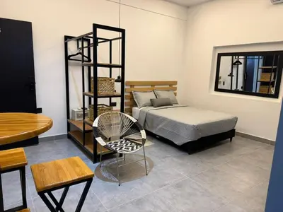 a bedroom with a bed and a table and a chair at Living Sincelejo in Sincelejo
