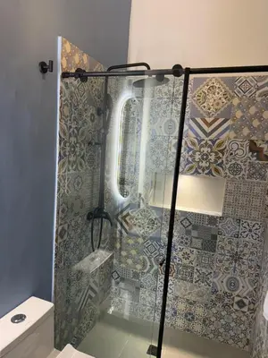 a shower with a glass door in a bathroom at Living Sincelejo in Sincelejo