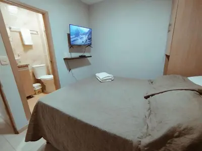 a bedroom with a bed with a television on the wall at Exclusivo Torices con Vista al Mar in Arizona