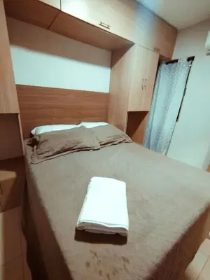 a bedroom with a bed with towels on it at Exclusivo Torices con Vista al Mar in Arizona