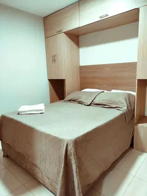 a bedroom with a large bed with a wooden headboard at Exclusivo Torices con Vista al Mar in Arizona
